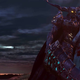 An armored man covered in blood carrying what might be a person draped over his shoulder walks away from a